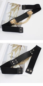 Detail of elastic waist belt featuring gold chain links and snap button closure