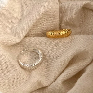 Detailed macro of S925 sterling silver stamp on textured minimalist croissant ring