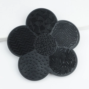 Detail of flower-shaped black silicone makeup brush cleaning mat with various textures