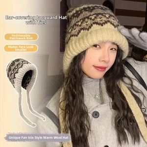 Detailed knit texture of Fair Isle earflap hat with long braided straps and beige pattern