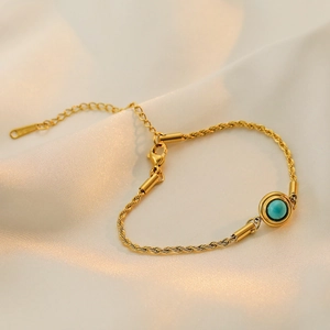 Gold-plated twisted chain bracelet with round turquoise gemstone on white silk
