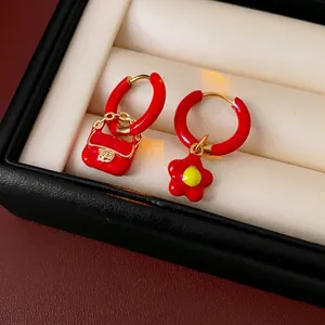 Asymmetric red enamel flower and handbag charms on titanium steel gold hoop earrings