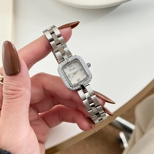 Elegant silver square quartz watch with diamond bezel and metal link bracelet on wrist