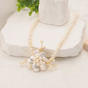 Detailed view of Baroque flower pendant with natural freshwater pearls and golden accents