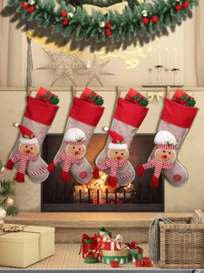 Set of 4 burlap gingerbread man Christmas stockings hanging on a warm fireplace mantel