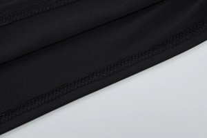 Macro shot of the black elastic V-neck vest showing detailed hem stitching and smooth fabric