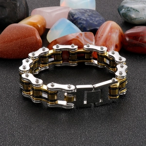 Macro detail of tricolor 304 stainless steel motorcycle chain bracelet with secure fold-over clasp