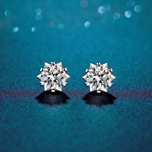 Close-up of D color moissanite stud earrings in 925 silver with starburst prong setting