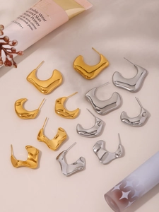 Modern irregular C-shape metal stud earrings set in gold and silver finish with liquid texture