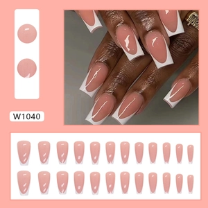 Detail view of 24pcs long coffin press-on nails with nude pink base and white V-shape tips