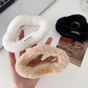 Detailed close-up of fluffy faux fur hair claws in cream, black, and khaki tones