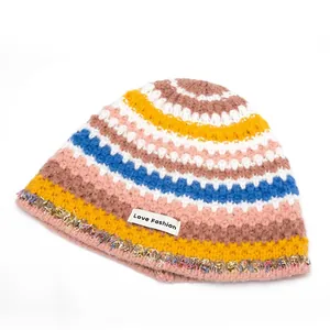 Rainbow striped knit beanie with Love Fashion label and colorful fringe detail