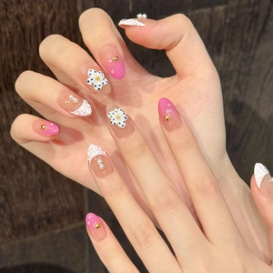 Pink French press-on nails with shell texture, floral charms and pearl accents