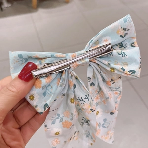 Light blue floral chiffon bow hair clip with silver metal alligator grip for women