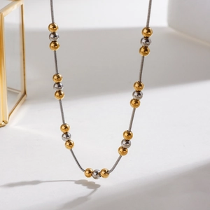 Minimalist gold and silver beaded necklace with thin snake chain in stainless steel