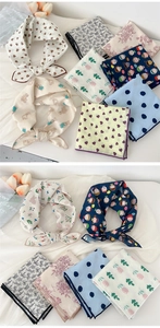 Close-up of cotton linen scarves featuring diverse patterns like bears and floral prints