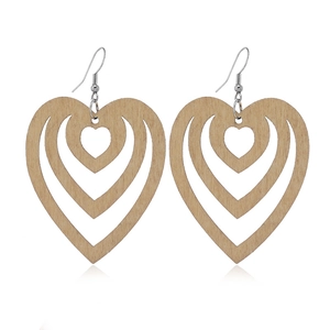 Detailed view of layered hollow heart-shaped wooden earrings with natural wood grain