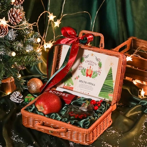 Christmas woven gift basket set with festive red apple, skincare and holiday ornaments