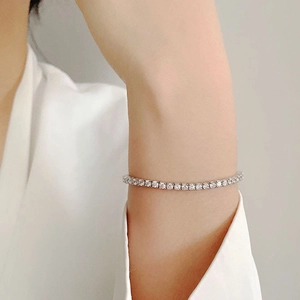 Macro detail of a silver tennis bracelet with sparkling round-cut cubic zirconia stones