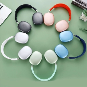 Top view of multiple colorful wireless over-ear headphones arranged in a circle on desk