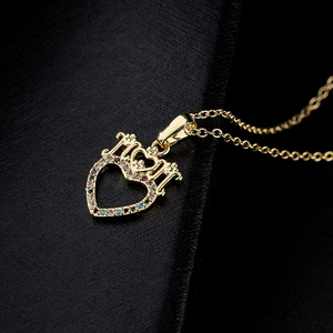 18K gold plated heart and crown pendant necklace with colorful zircons on a dark background