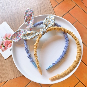Floral bow headbands in blue and yellow fabric for little girls in a decorative tray
