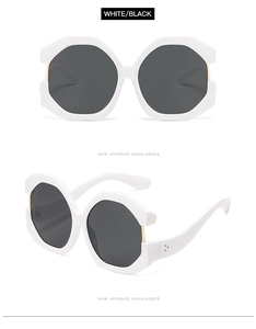 Detail of oversized white geometric frames with black lenses and golden metal hinges