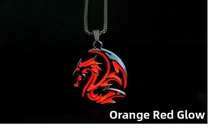 Detail of dragon pendant showing intense orange-red glow effect in dark background