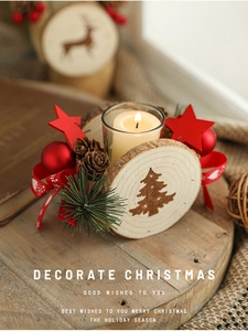 Detail of wooden Christmas candle holder with pine cones and starry decorations