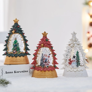 Christmas tree snow globes in red, white and green with festive miniature scenes