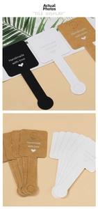 Detailed view of tricolor handmade jewelry tags in black white and kraft paper colors