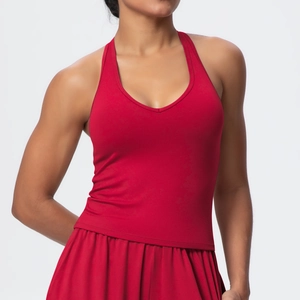 Detail of dark red V-neck sports bra and pleated skort with brushed matte texture
