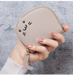 Close-up of cute cat wallet showing lychee grain texture and metal zipper detail