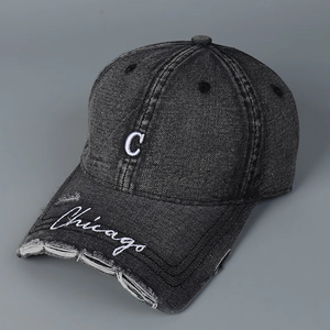 Detail of distressed brim on washed black denim baseball cap with Chicago embroidery