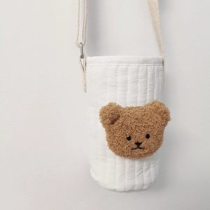 Close-up of quilted white cotton water bottle bag with cute 3D plush bear head detail