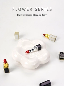 Close-up of a white floral ceramic storage tray with five petals and high gloss finish