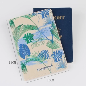 Close-up of a faux leather passport cover with tropical leaves and 14x10cm dimensions