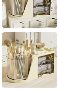 Close-up of cream desktop organizer with rotating brush holder and clear drawers for stationery
