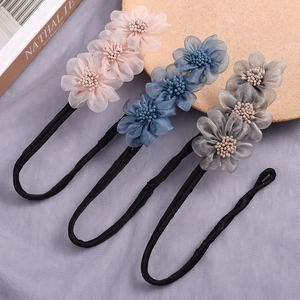 Detail view of three vintage flower hair bun makers in pink blue and grey colors