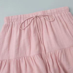 Detailed view of pink crinkle fabric waist with drawstring on elastic tiered shorts