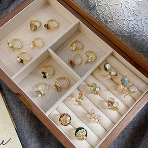 Collection of vintage gold-tone rings with colorful enamel floral and pearl details