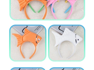 Collage of plush fish headbands in orange, white, pink and blue on lace background