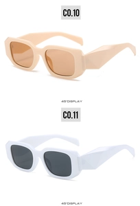 Detail view of rectangular sunglasses showing angular thick frames in cream and white