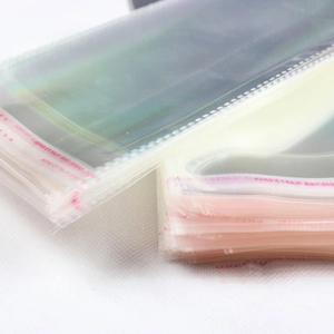 Transparent iridescent self-sealing packaging bags for socks with adhesive strip closure