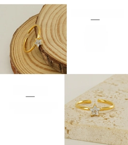 Macro detail of adjustable gold plated star ring featuring a cubic zirconia stone inlay