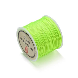 Macro detail of 0.8mm neon green polyester cord spool for DIY jewelry weaving