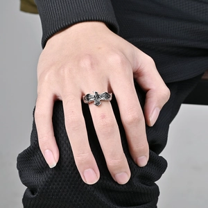 Detailed close-up of vintage Celtic knot eagle ring with oxidized steel texture on finger
