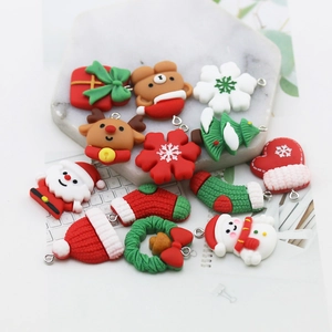 DIY Christmas resin charms set with Santa, reindeer and tree shapes on marble background