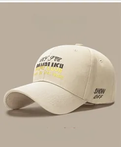 Detailed close-up of beige twill cotton baseball cap with DAMP LUSH embroidery art