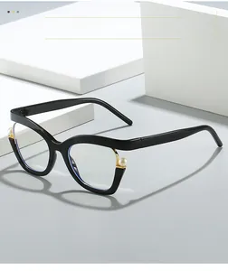 Close-up of cat-eye glasses with pearl embellishments on a minimalist white pedestal
